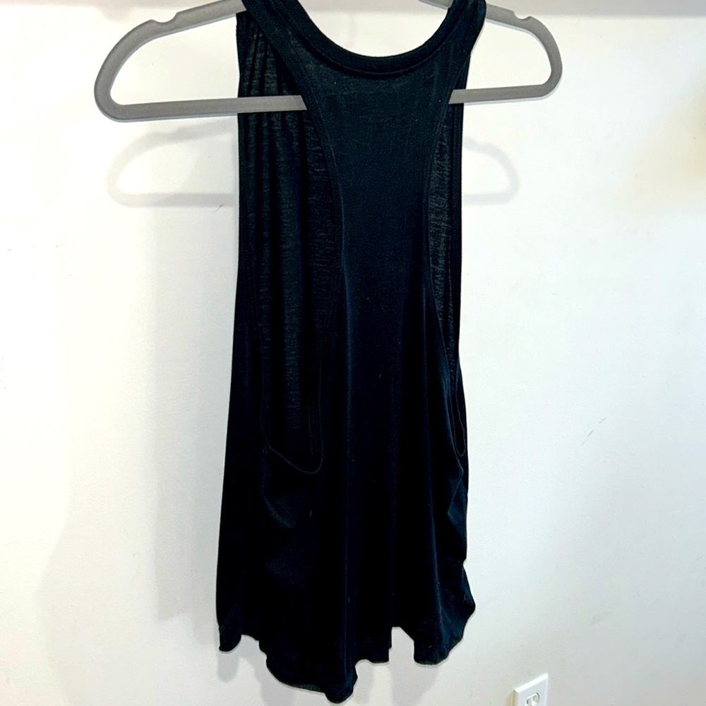 Black tank top with open arm holes and stretchy